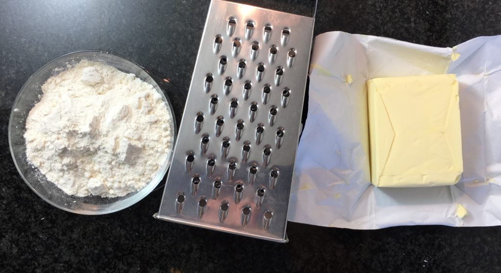 preparing-pastry-crust-female-hands-cutting-butter-into-the-flour-with